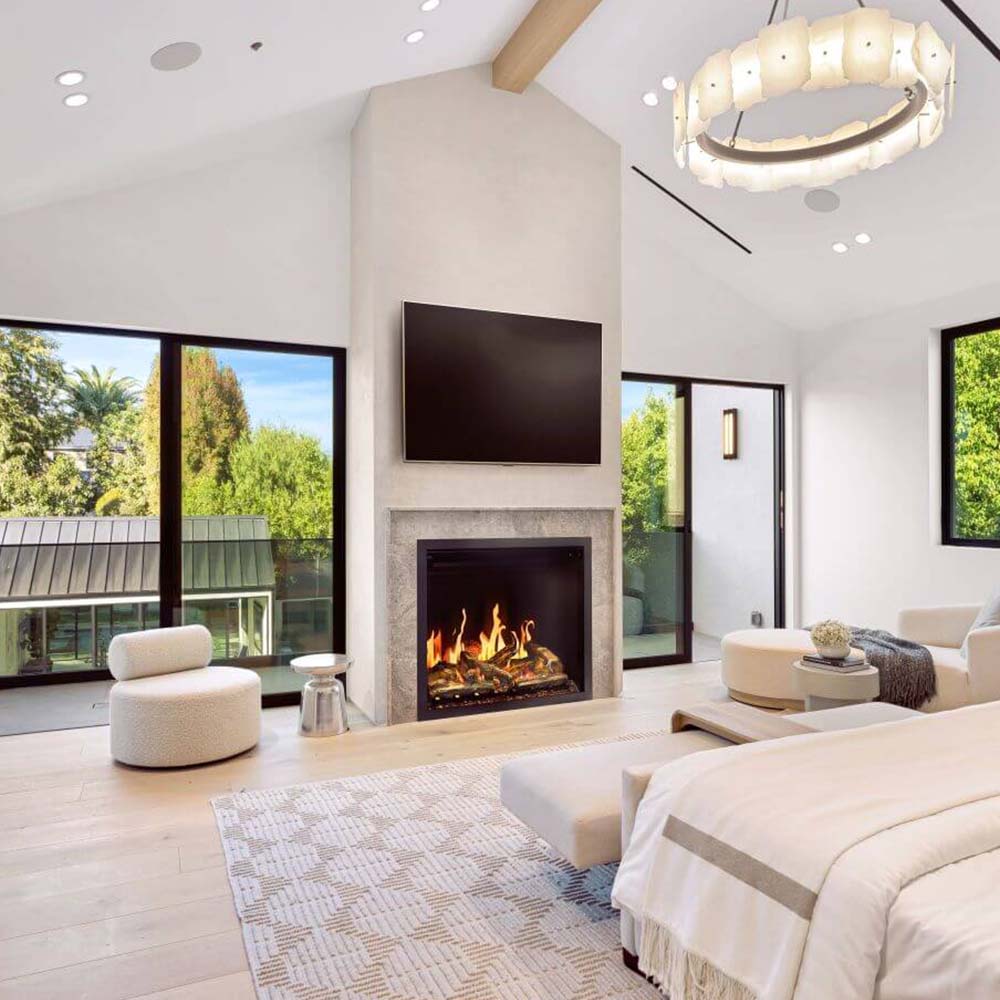 Built-in electric fireplace with lit flame display set in a white stone surround