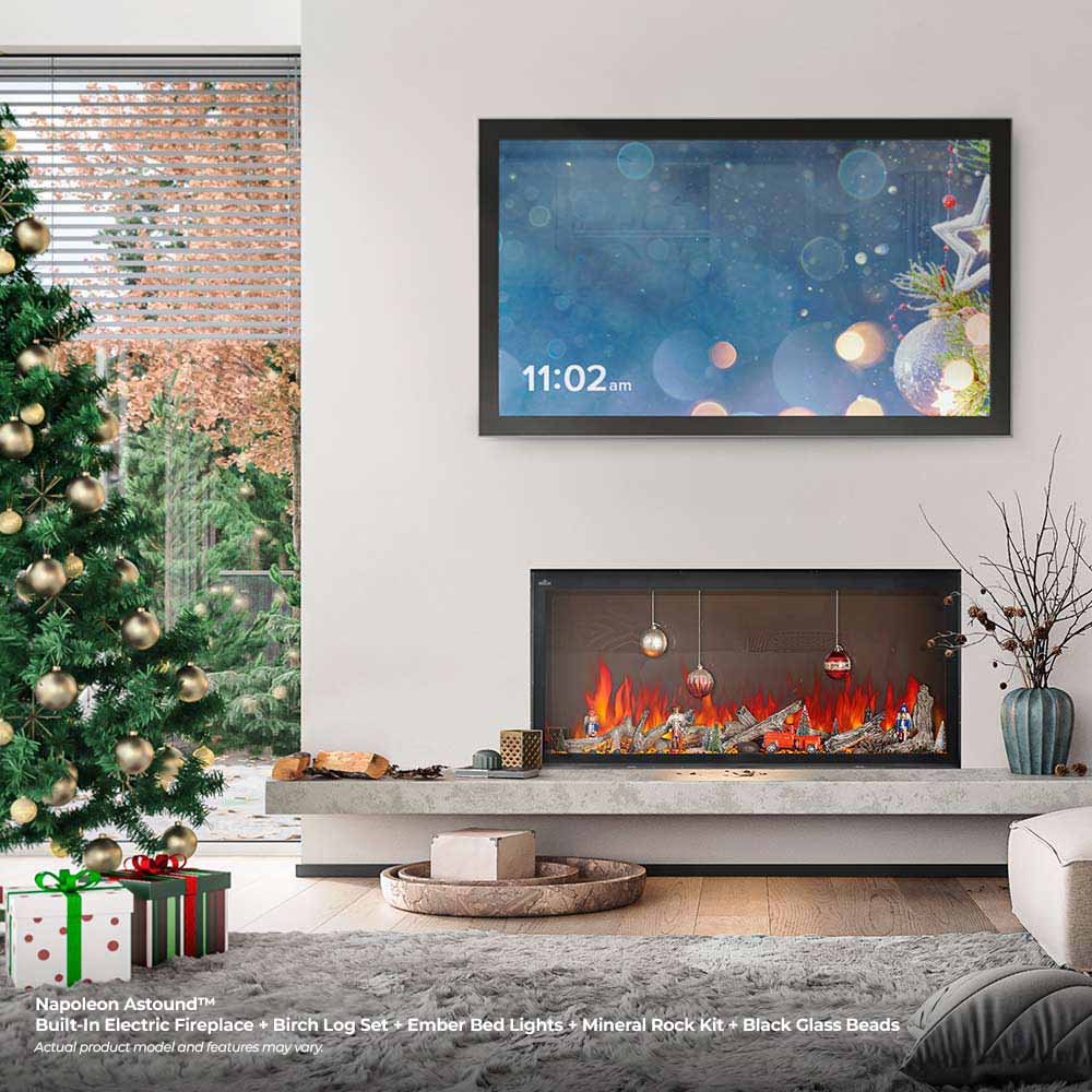 Built-in electric fireplace with black trim, glowing flames, and hanging lights