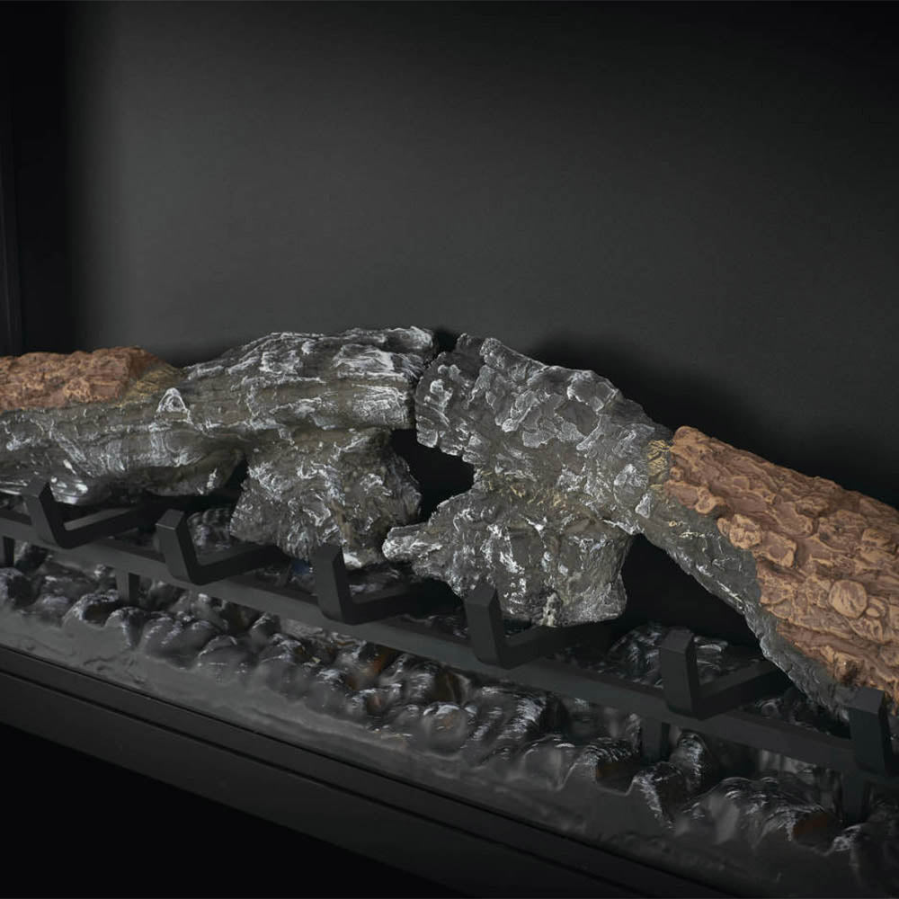 Faux fire logs and charcoal pieces inside an electric fireplace firebox