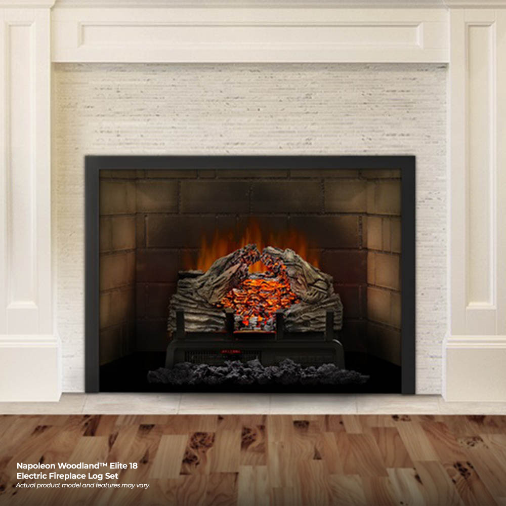 Electric fireplace log set in a white mantel with glowing orange embers