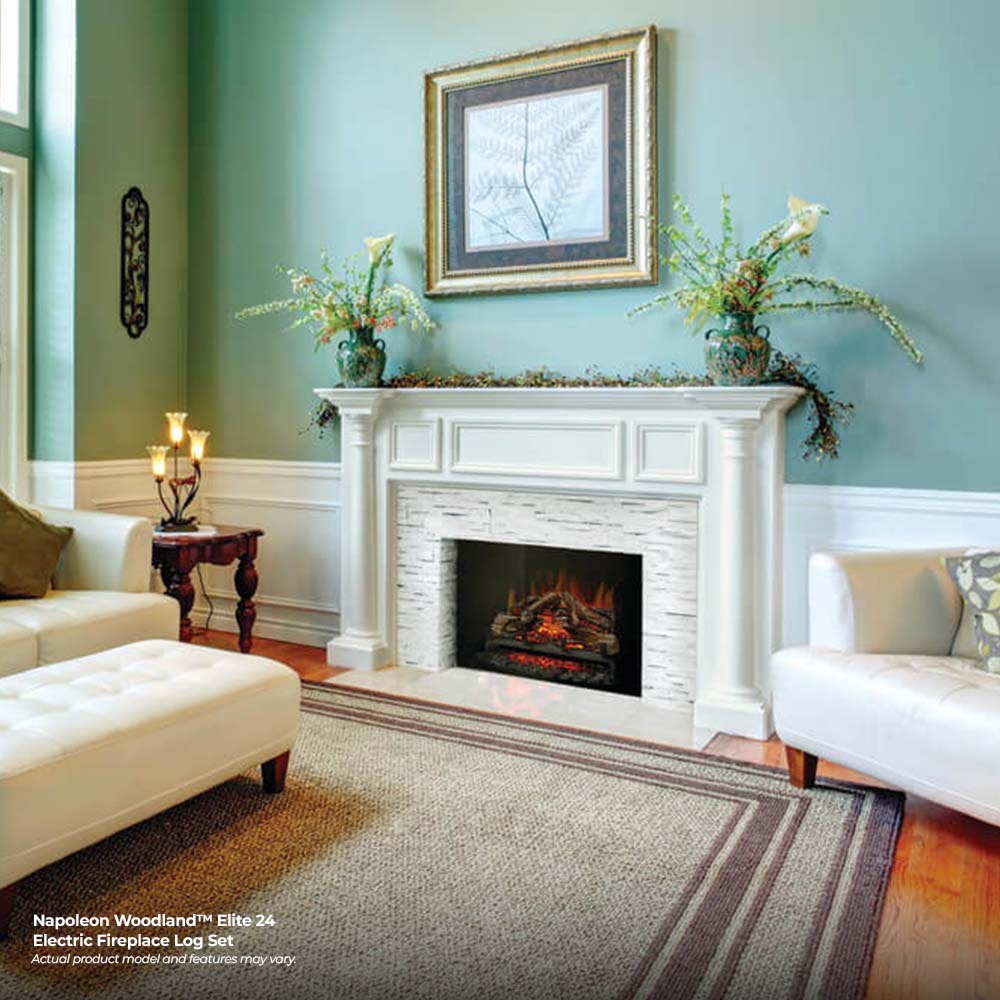 Electric fireplace log set in a white mantel with orange flame glow and gray logs