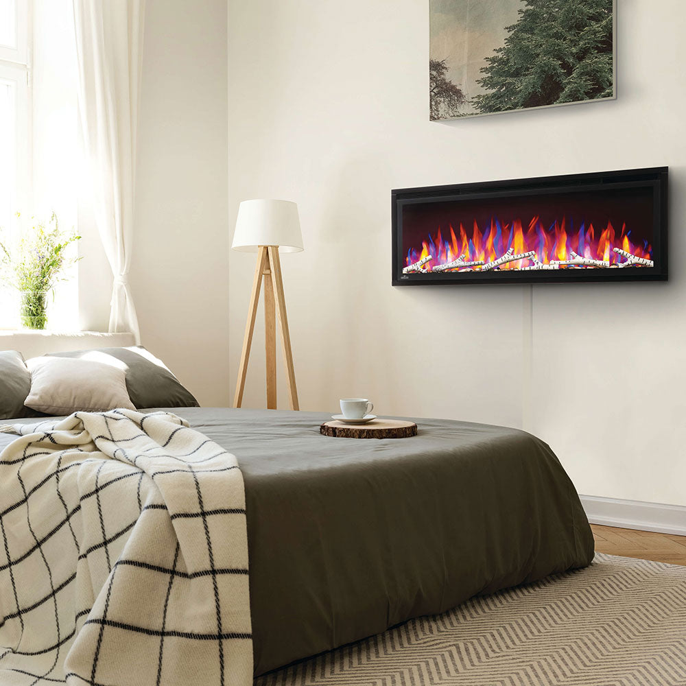 Birch log set with rocks in wall-mounted firebox, visible burning flames