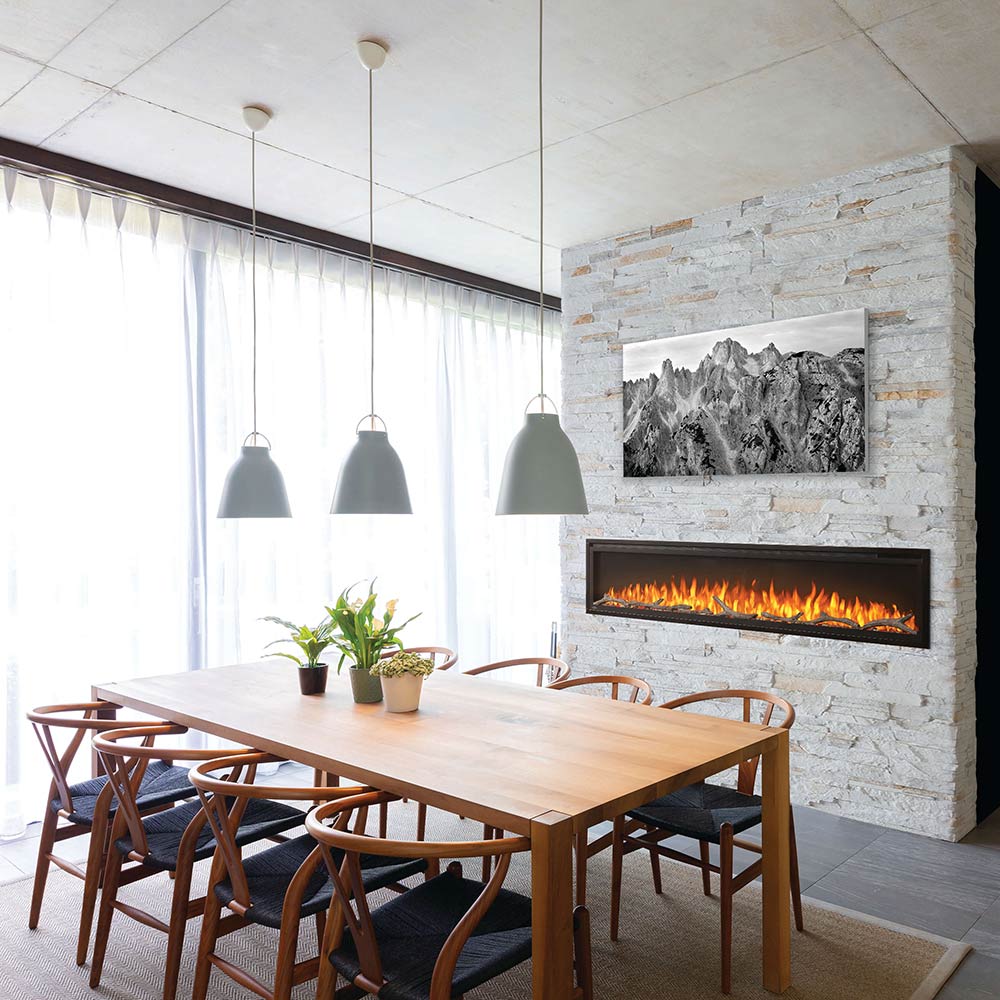Fireplace insert with driftwood logs, rocks, and active flames, centered in a room