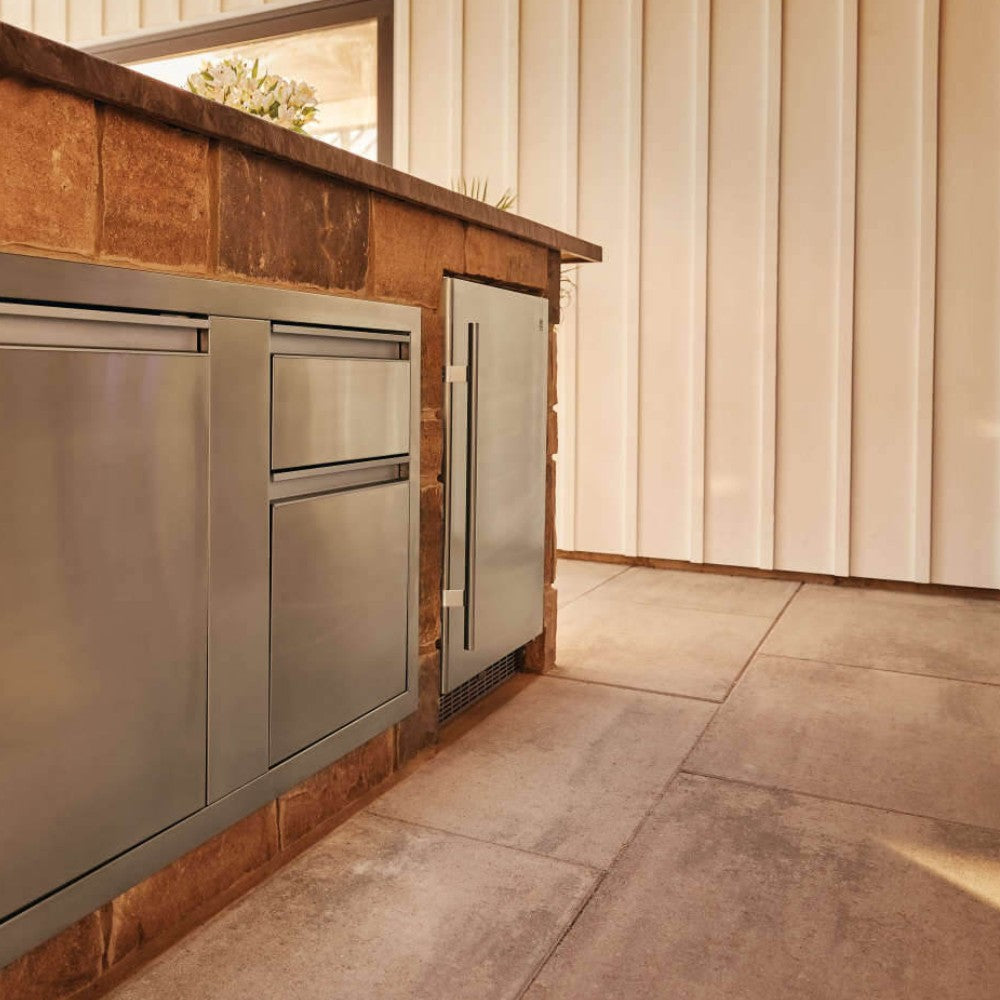 Outdoor stainless steel refrigerator built into outdoor counter, with side handle