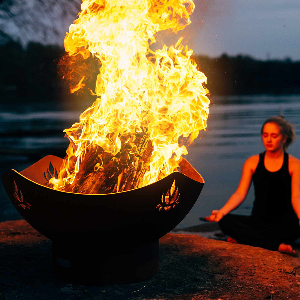 Black fire pit bowl with burning flames and lotus emblem, open top