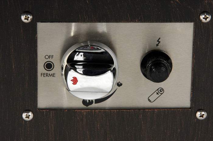 Fire table control panel with chrome ignition switch and surrounding control knobs