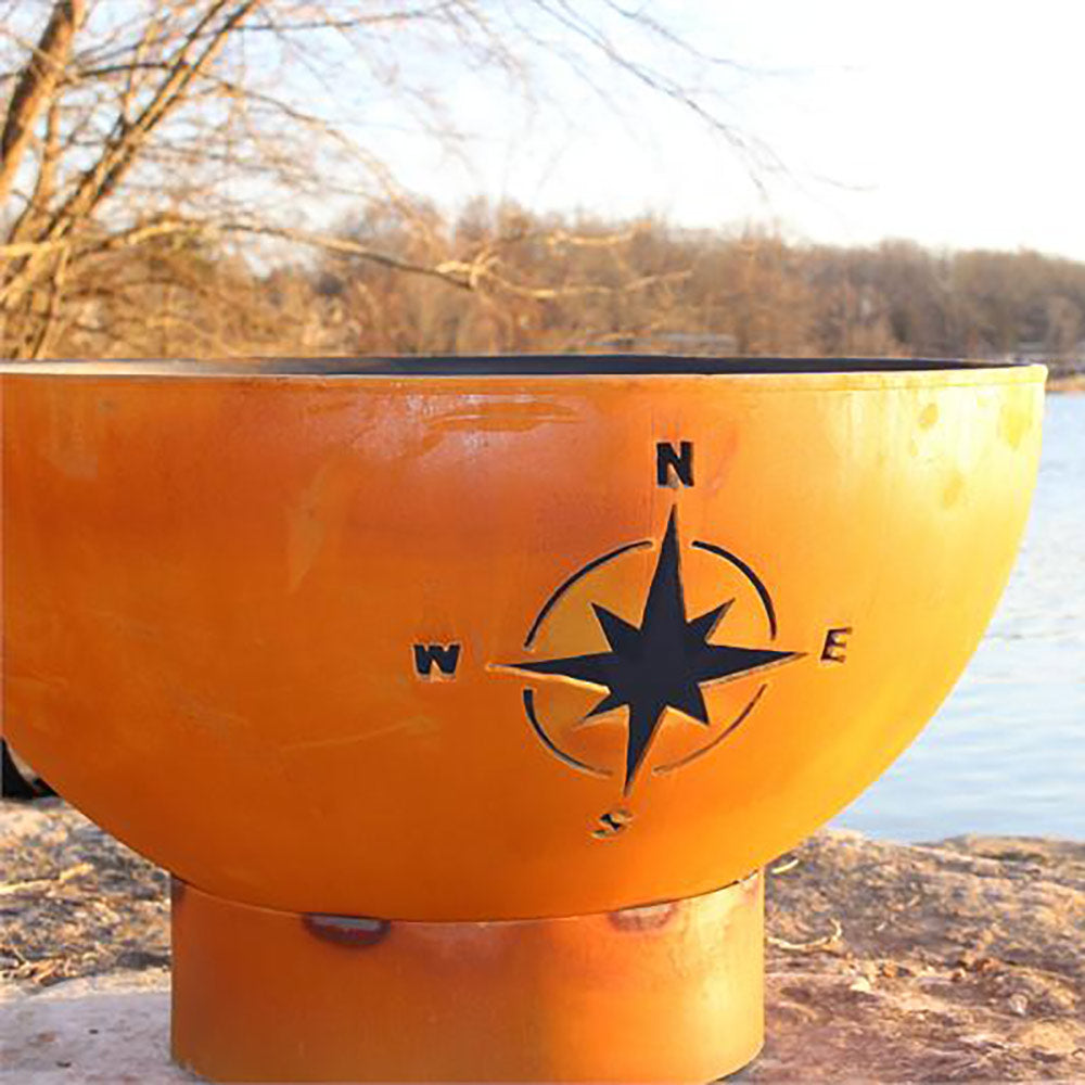 Orange gas fire pit bowl with star compass emblem on front