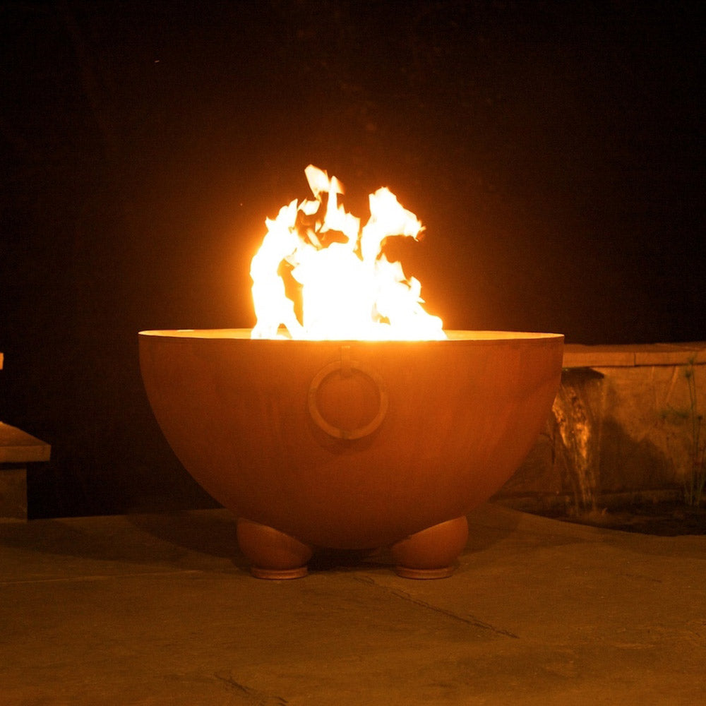 Gas fire pit bowl with flames rising above rim, round front air port