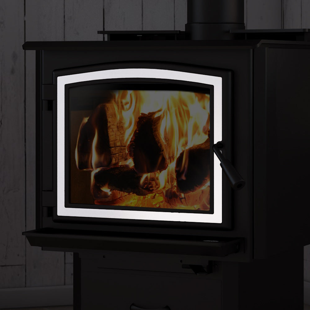 Brushed nickel door overlay frame around a wood stove glass window.