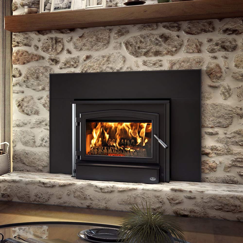 Wood-burning fireplace insert with black surround and glass door, flames visible