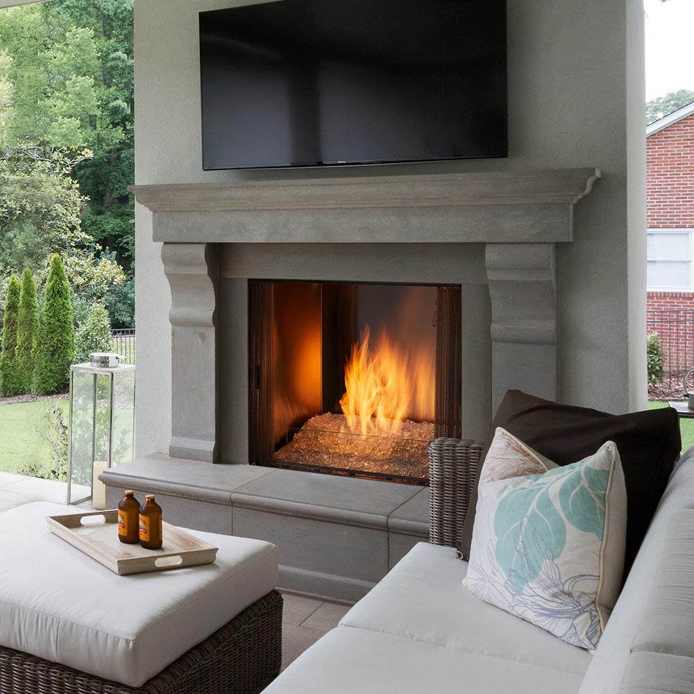 Gray outdoor natural gas fireplace with firebox flames and stone surround