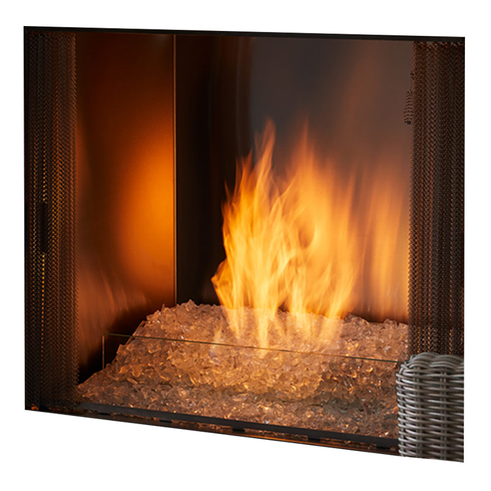Outdoor gas fireplace burner with glowing flames and dark fire glass bed