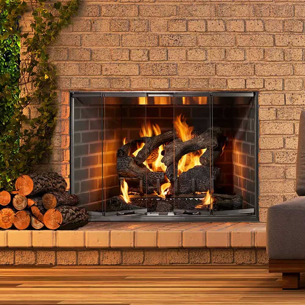 Outdoor wood fireplace set in brick surround with burning fire and logs