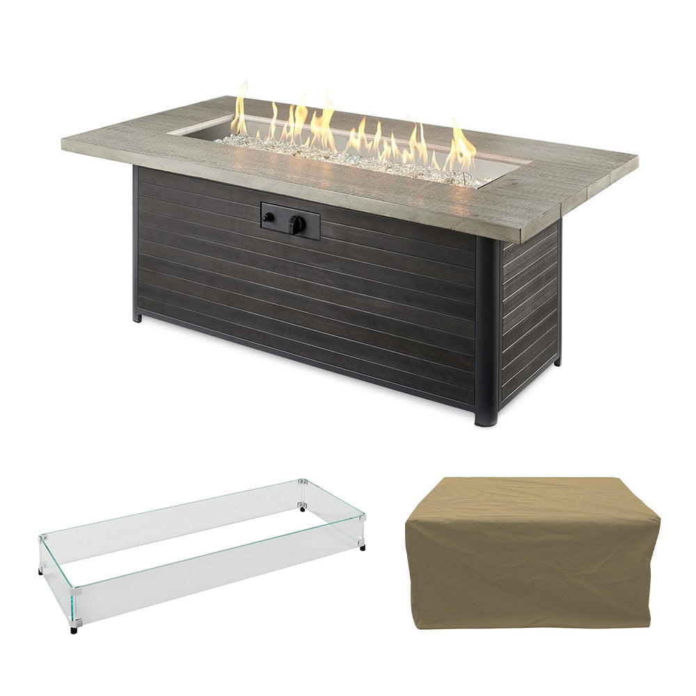 Gas fire pit table with dark base and gray stone top, burning flames
