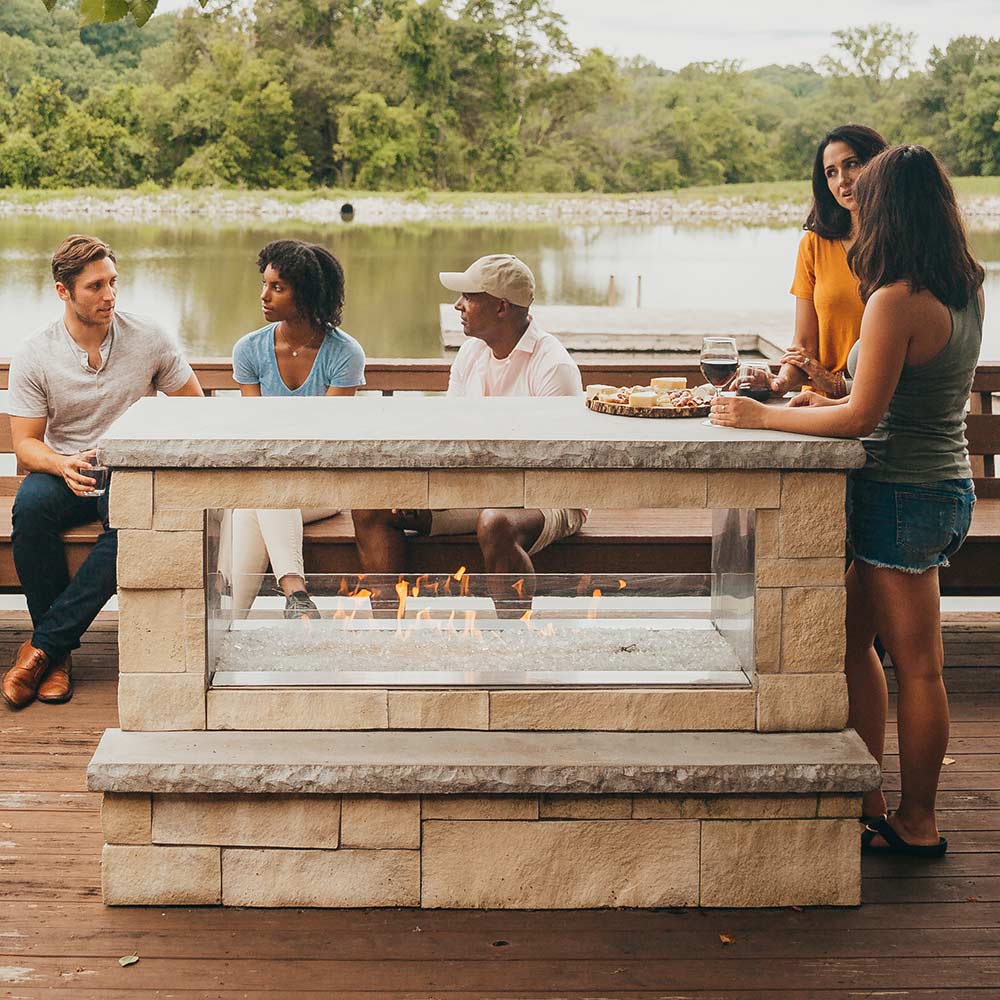 Outdoor see-through gas fireplace with burning flame bed and open front