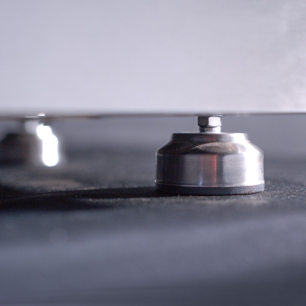 Commercial gas griddle cooktop surface with visible burner cap and raised metal controls