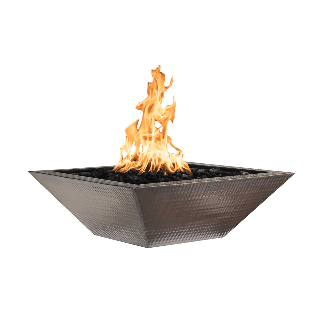 Copper square gas fire bowl with bright flames rising from dark burner