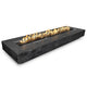 Rectangular wood grain concrete fire pit with flames in long burner, dark ebony finish