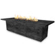 Rectangular wood-grain gas fire pit with visible flames, textured dark concrete finish