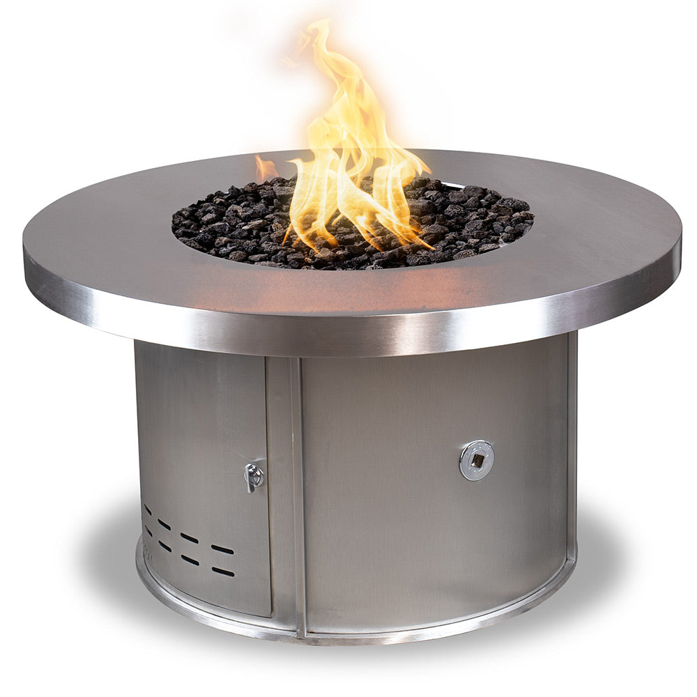 Round stainless steel gas fire pit with central flame and black lava rocks