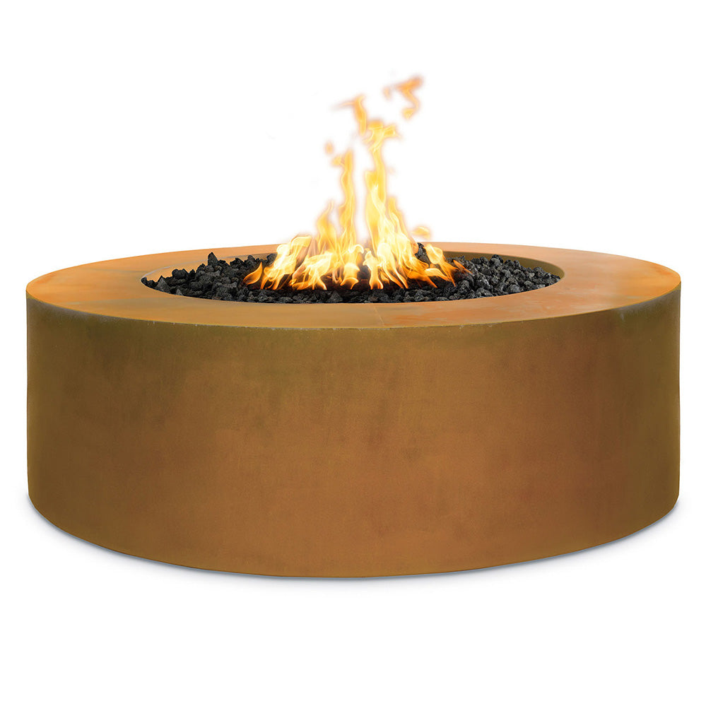 Round corten steel gas fire pit with burning flames over dark lava rocks