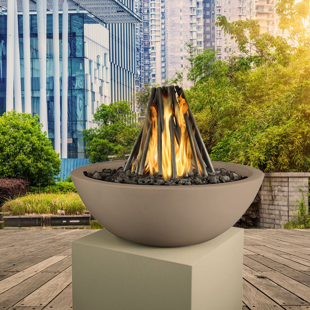 Outdoor fire pit with steel logs and orange flames in round gray bowl