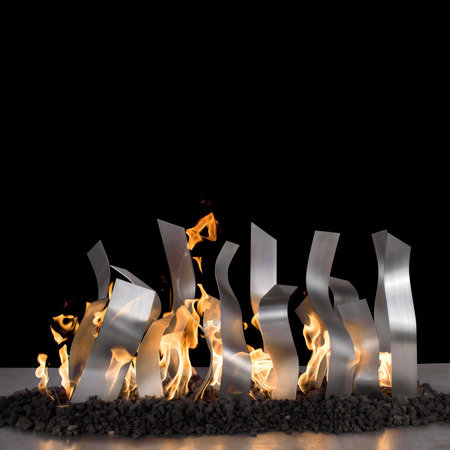Stainless steel tangled fireplace burner with visible flames behind panels