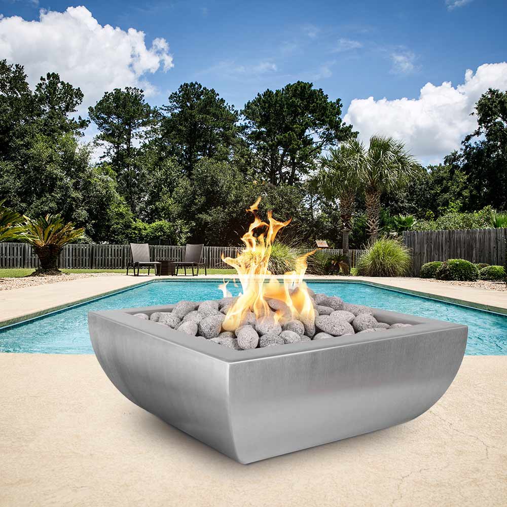 Square stainless steel gas fire bowl with burning flames over gray lava rocks