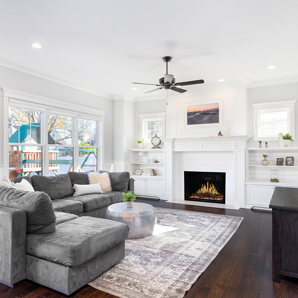 Built-in electric fireplace insert showing glowing flames and black glass surround