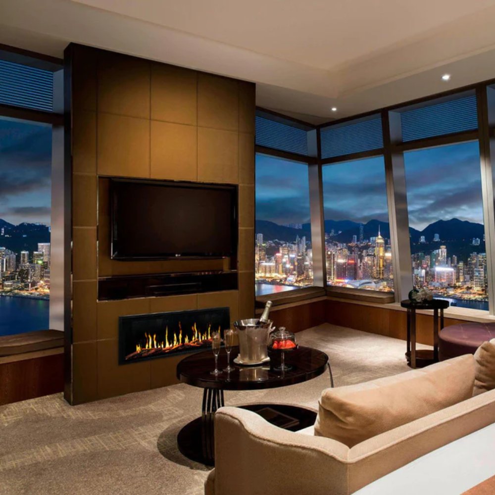 Linear electric fireplace inset in dark wall paneling with flame bed