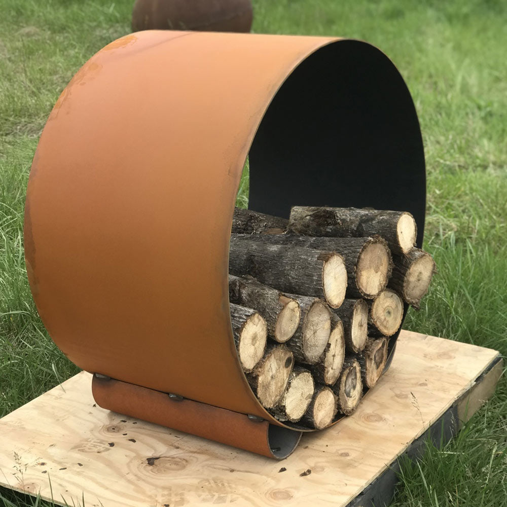 Curved orange steel log rack with black interior and stacked firewood