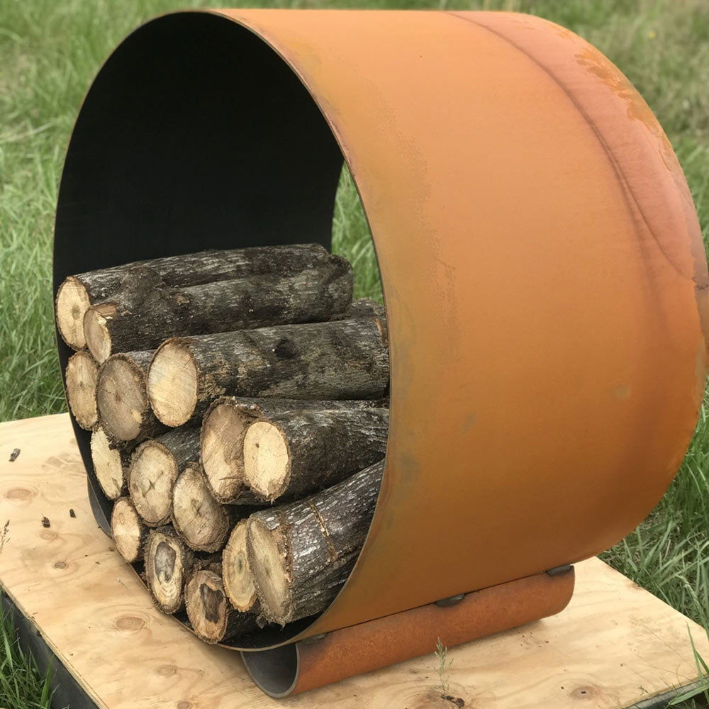 Curved orange steel log rack with black interior and visible log ends