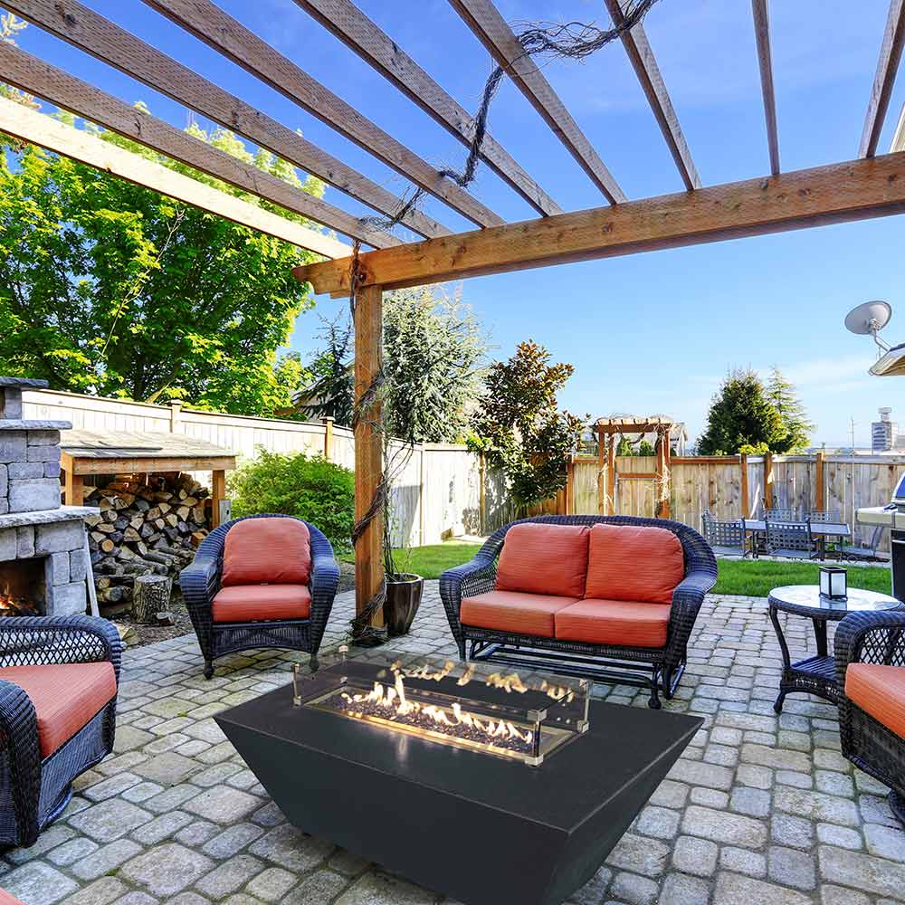 Rectangular black propane fire pit with flames burning along the burner tray