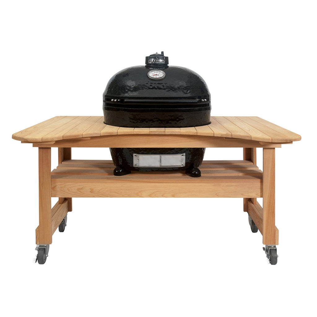 Charcoal oval ceramic kamado grill on light wood cart with caster wheels