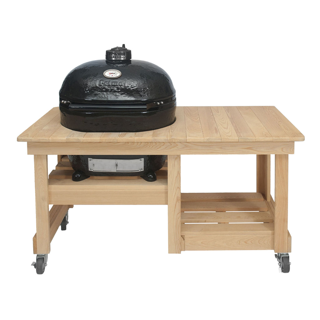 Charcoal oval ceramic kamado grill on light wood countertop table with side shelf