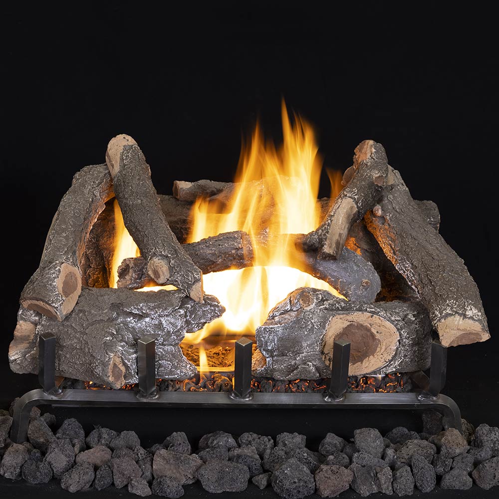 Charred oak-style gas log set with glowing flames and dark ceramic logs
