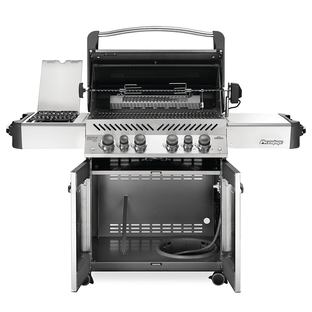 Stainless steel gas grill with hood open, interior burners, and rotisserie-style area