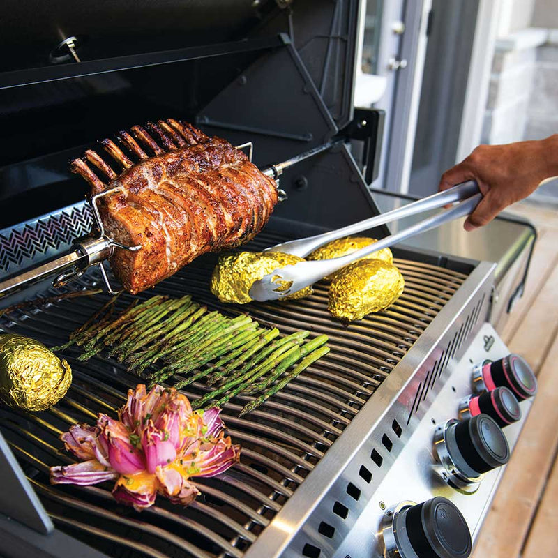 Grilling meat, asparagus, and vegetables on a barbecue grill from Napoleon