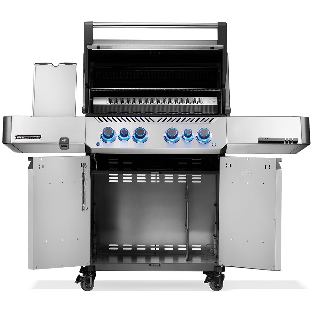 Open-lid gas grill on cart showing cooking grates and burner area inside