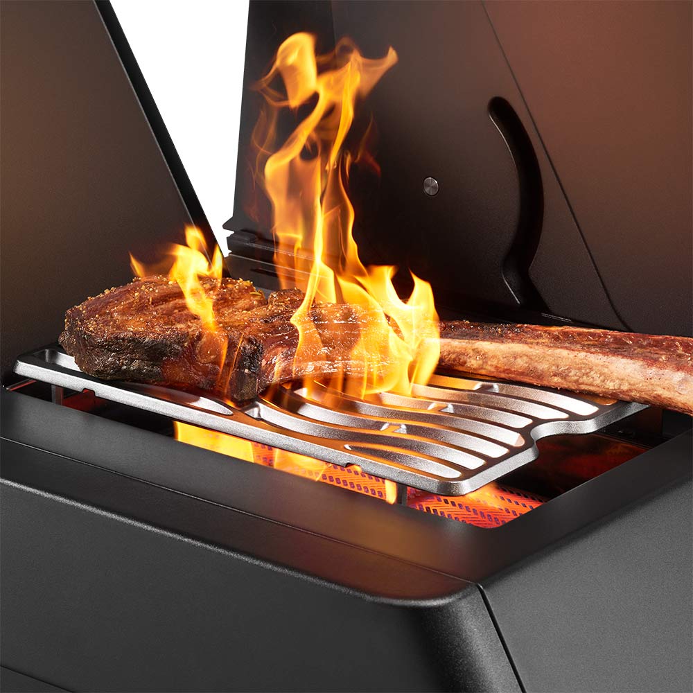 Gas grill with flames rising from cooking grate under infrared burners
