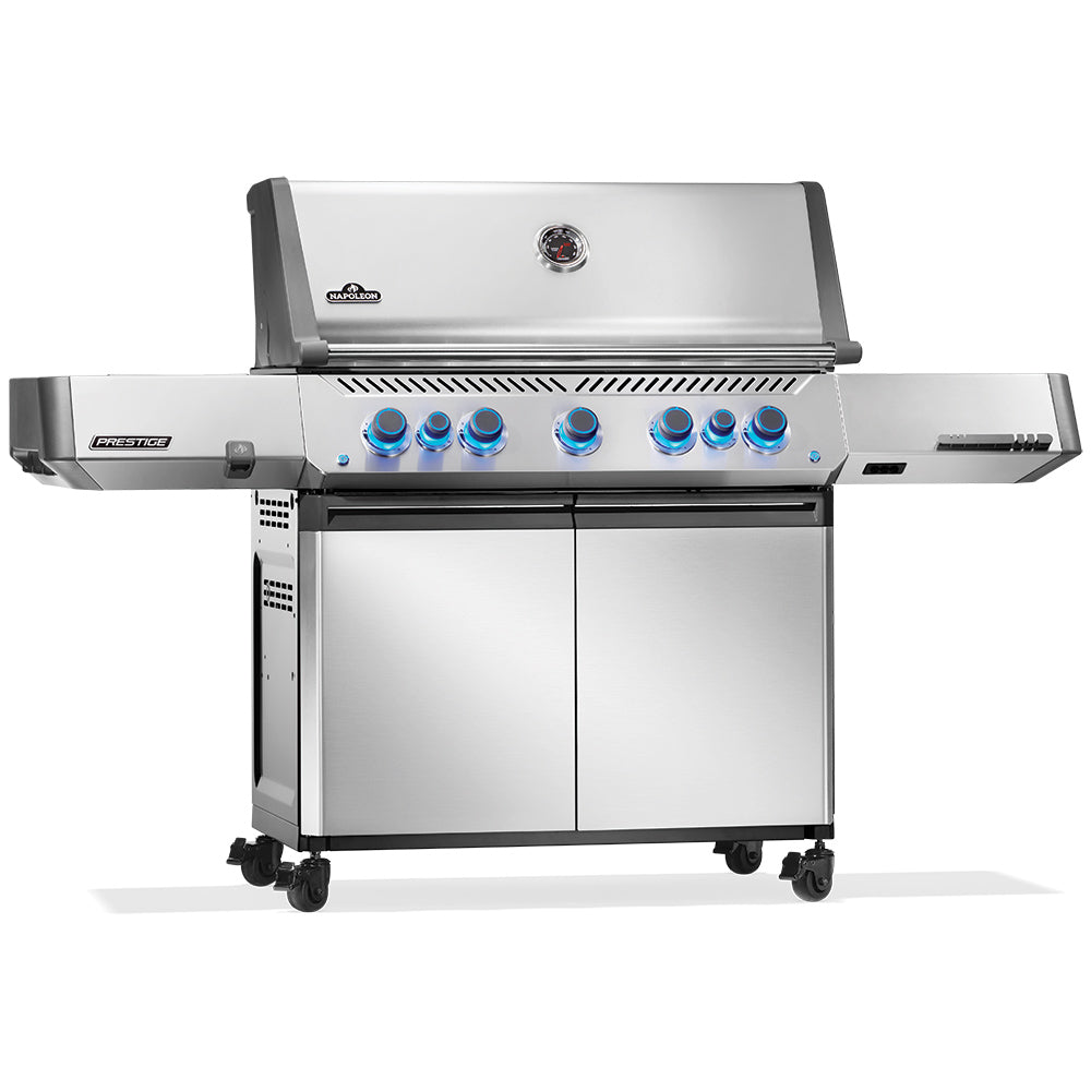 Stainless steel gas grill on wheeled cart with blue-lit control knobs and cabinet doors