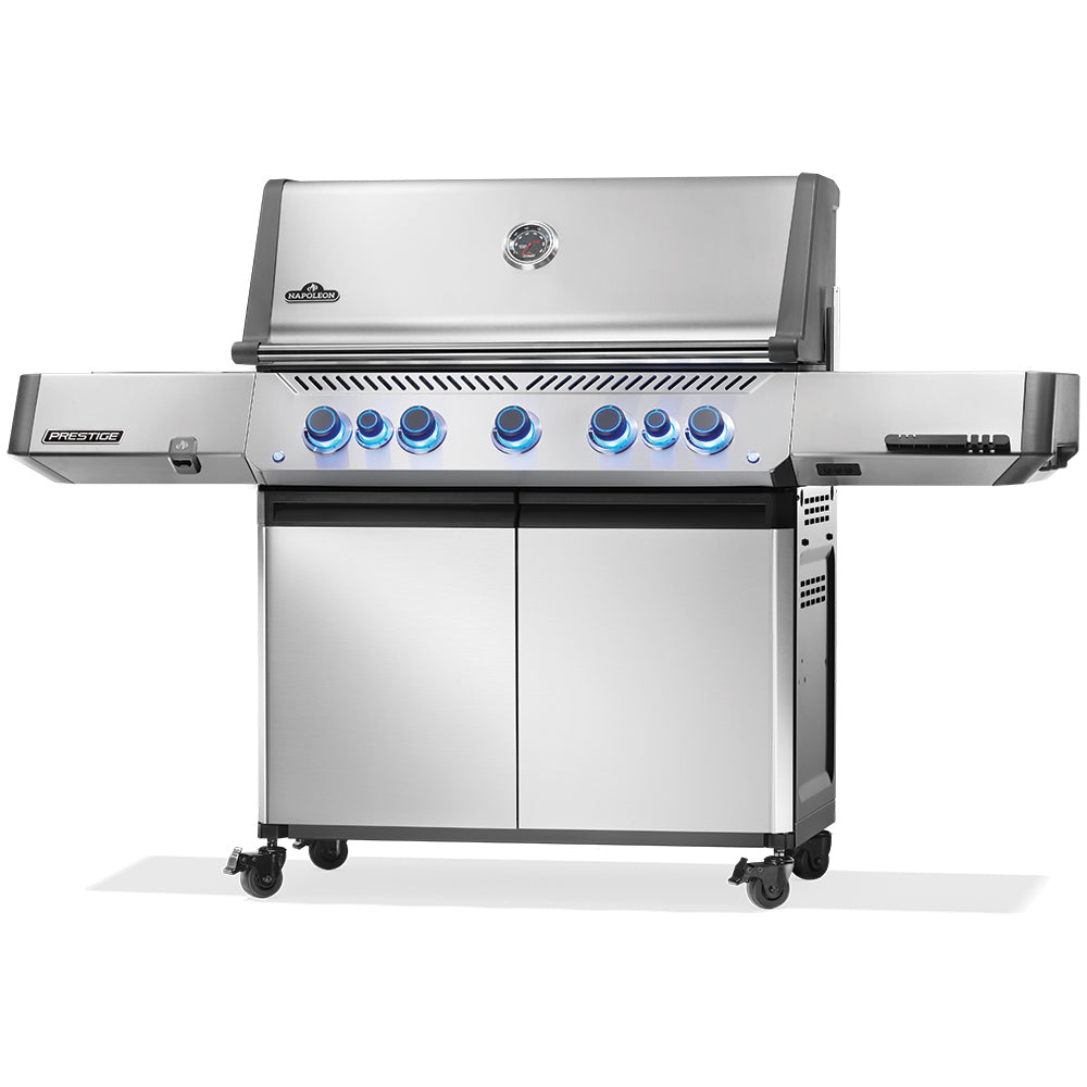 Stainless steel gas grill with control panel, side shelf, and two-door cabinet base