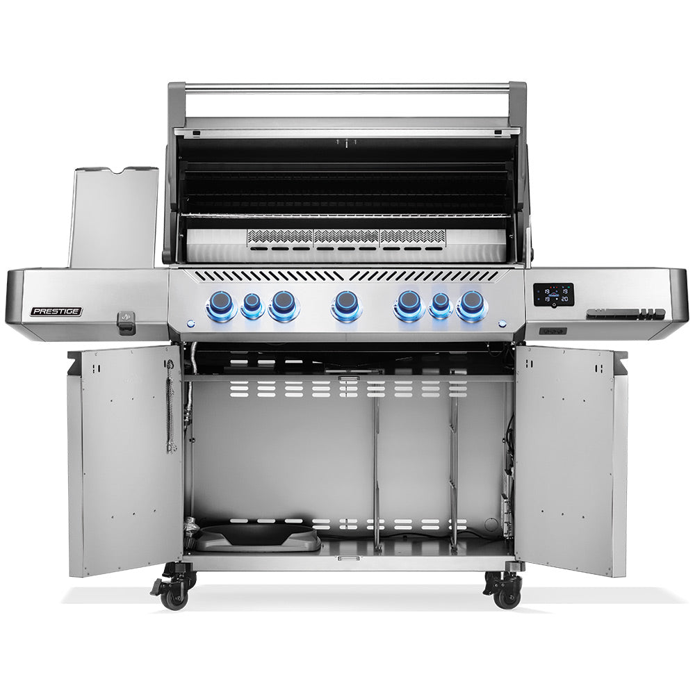 Open stainless gas grill on cart with burners and blue control knobs visible.