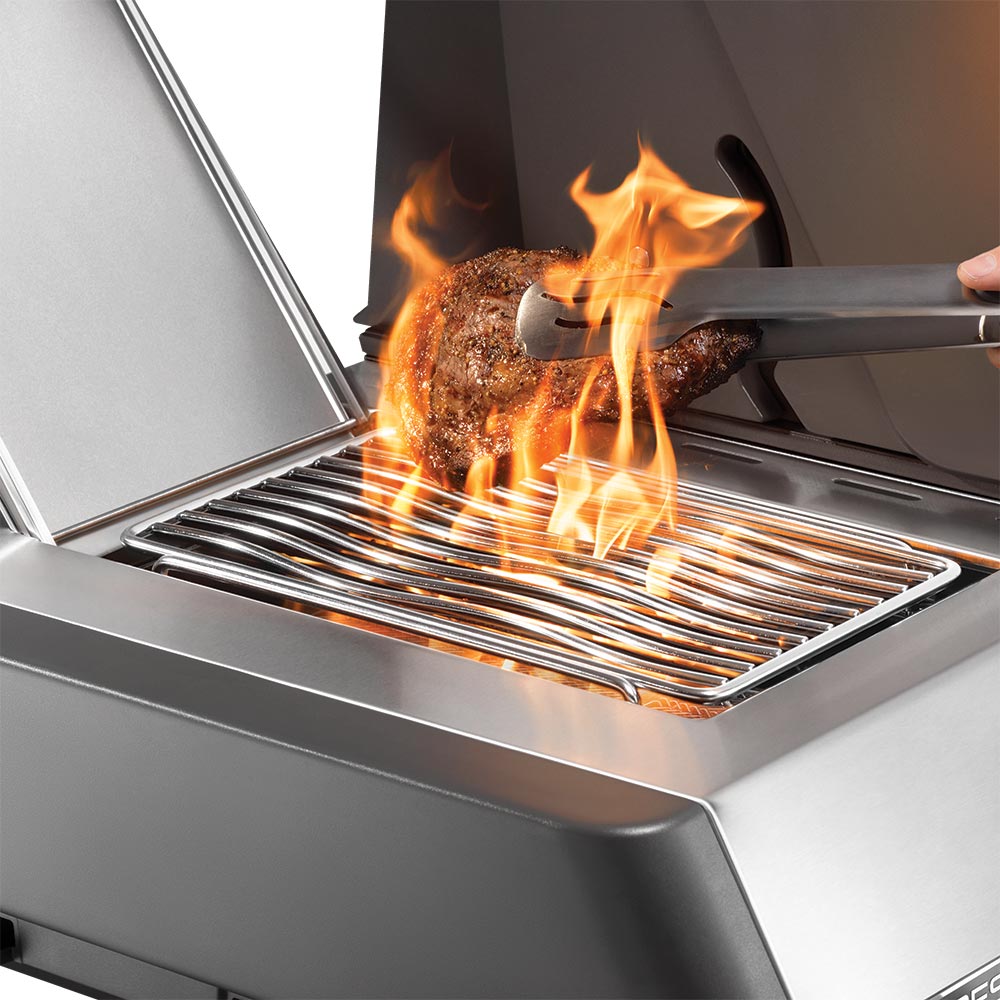 Gas grill burner tray with flames over the burner tubes.