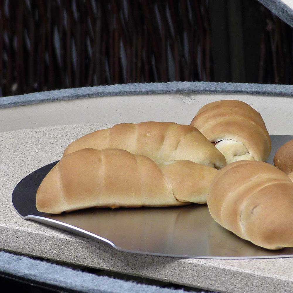 Oval baking stone with braided bread loaf on top