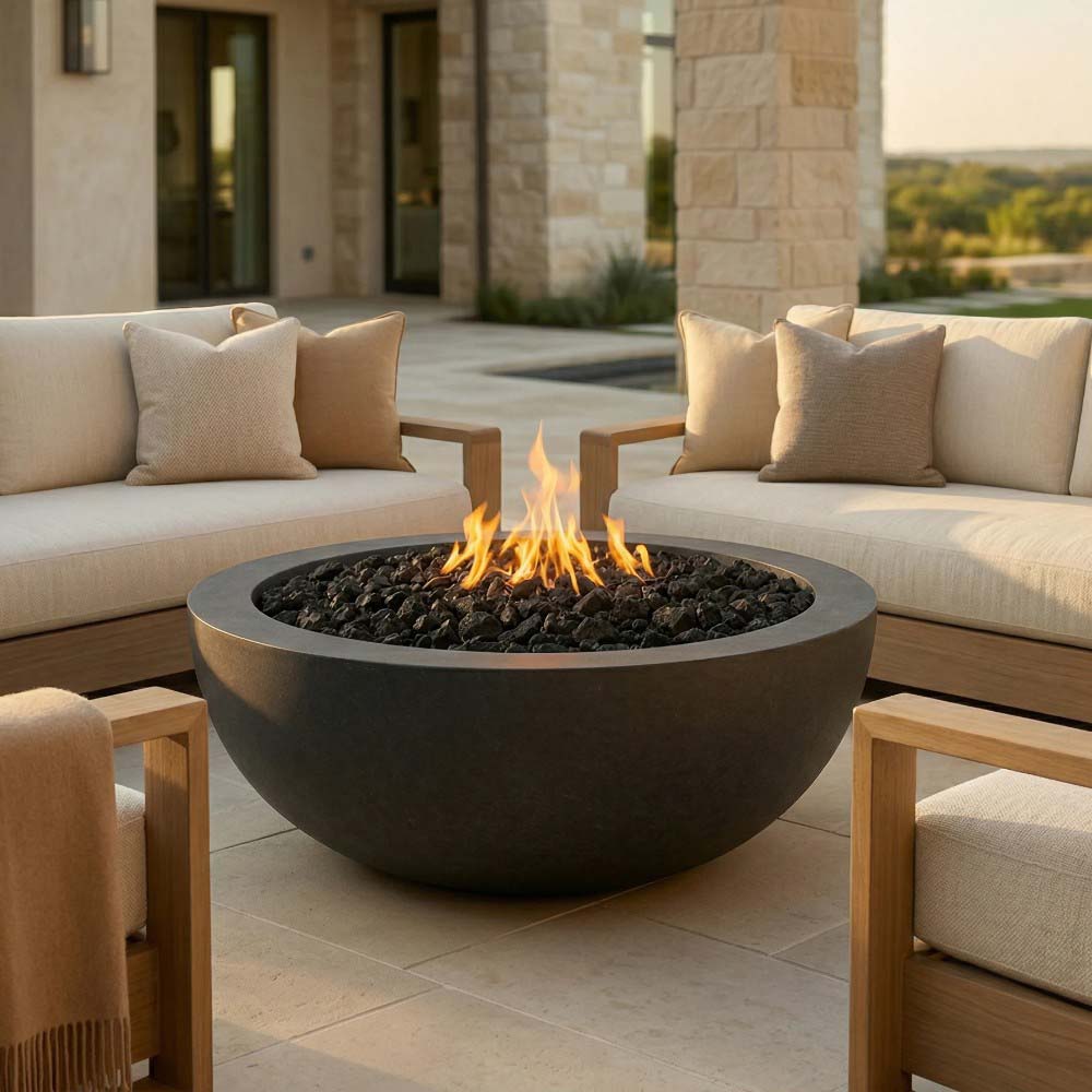 Round concrete gas fire pit with flame and dark lava rocks