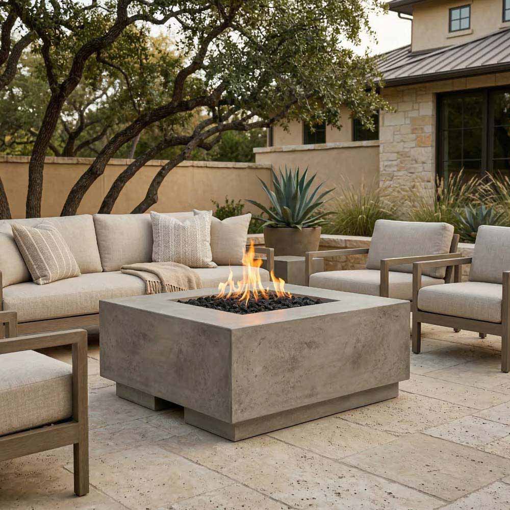 Square gray concrete gas fire pit with visible flame and dark burner insert.