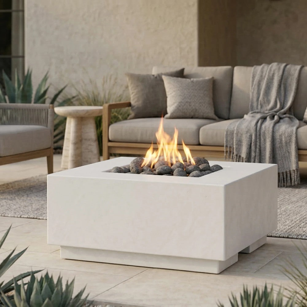 Light gray concrete gas fire pit with visible flame and black lava rock insert.