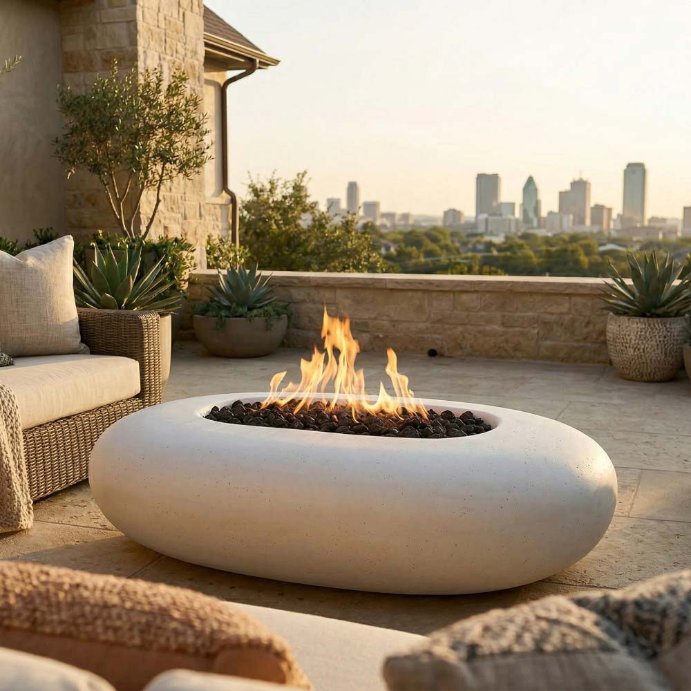 Pebble concrete gas fire pit with visible flame in a patio setting