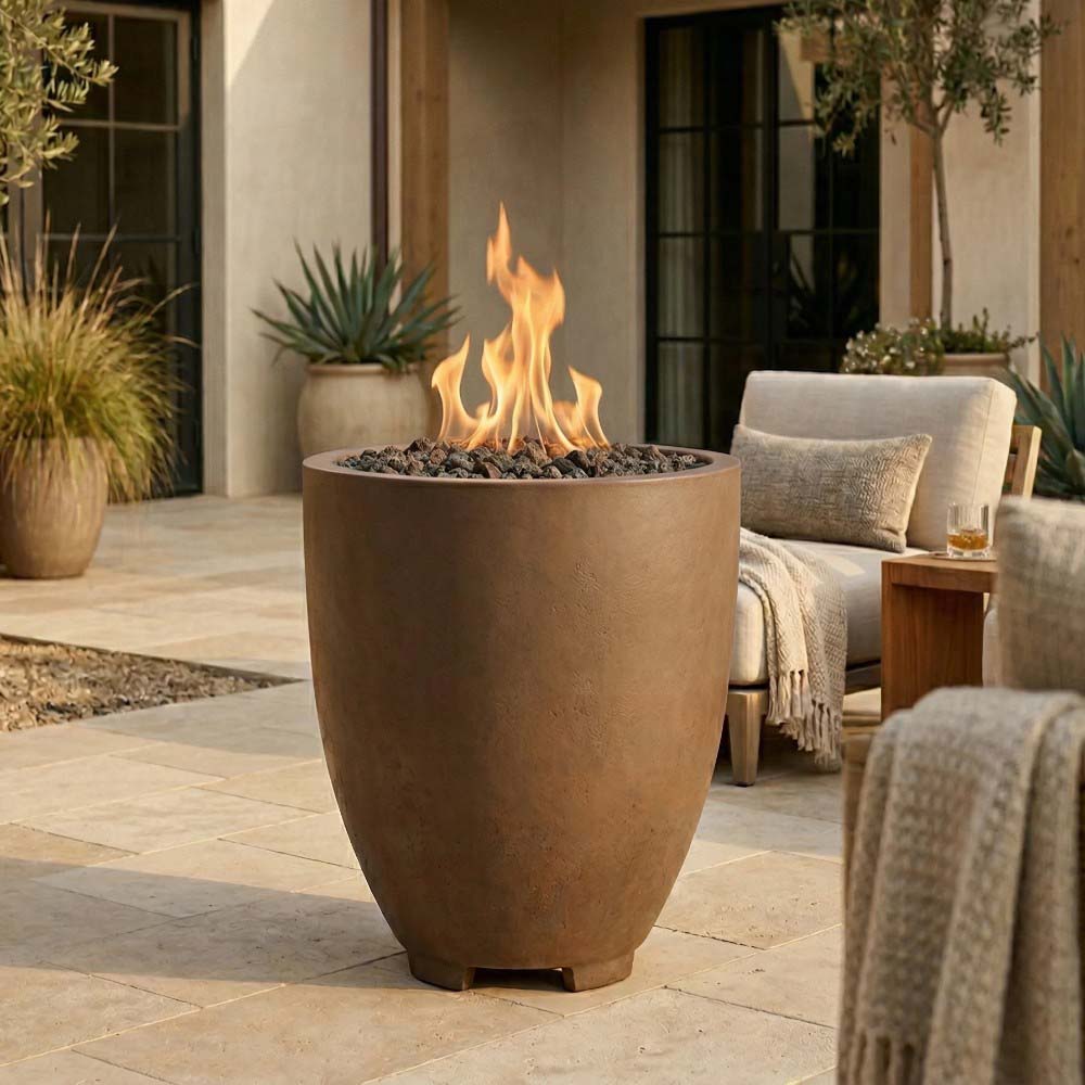 Tan concrete gas fire pit with flame, rounded bowl and four support feet